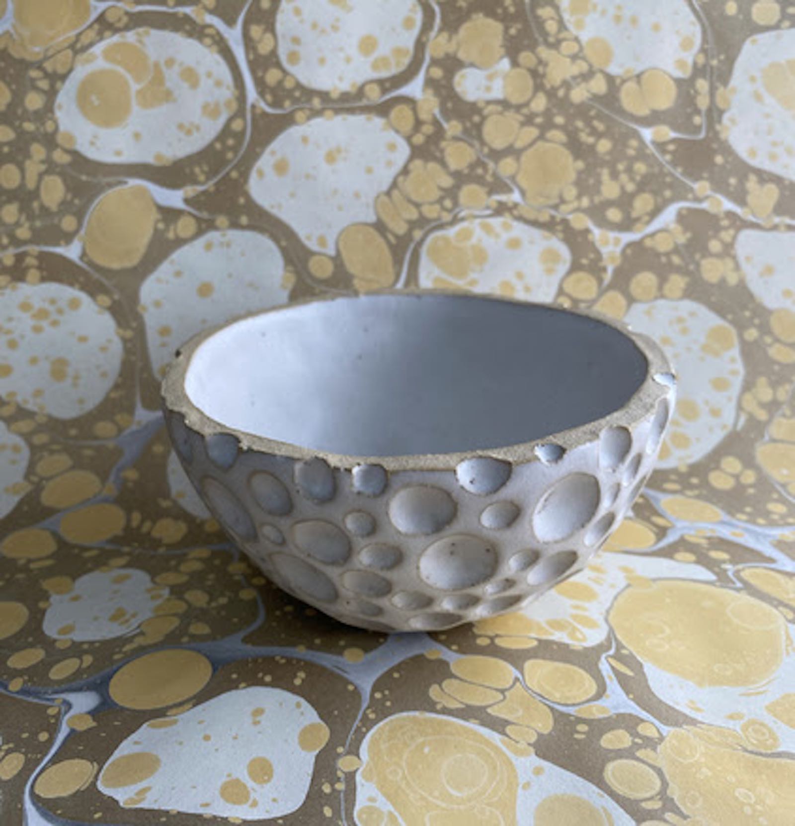 Paula McCartney’s installation will include an artist’s book, marbled papers, and ceramic sculpture