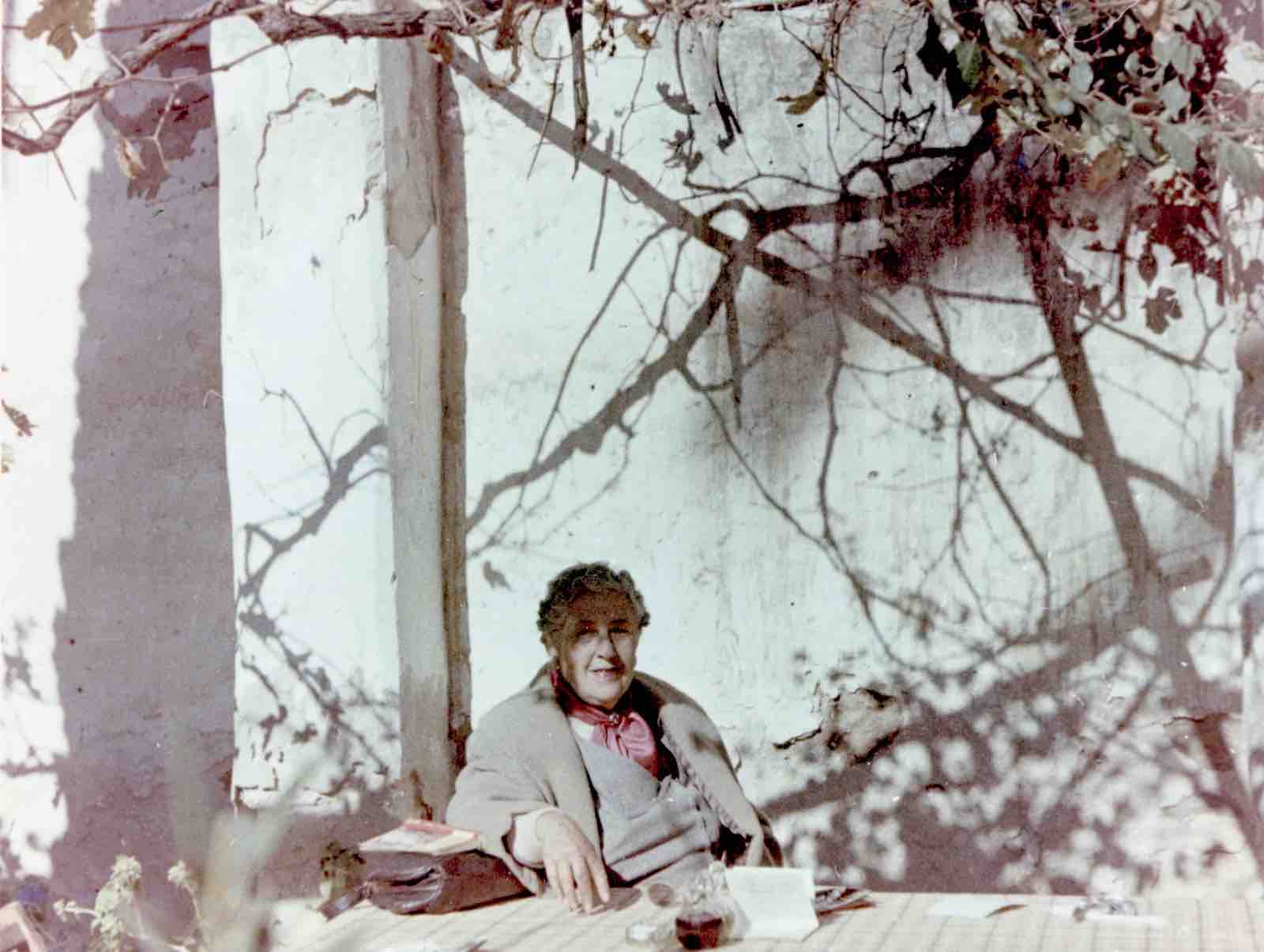 Agatha Christie relaxing during a sightseeing tour, Tajoura, Libya, 1955.