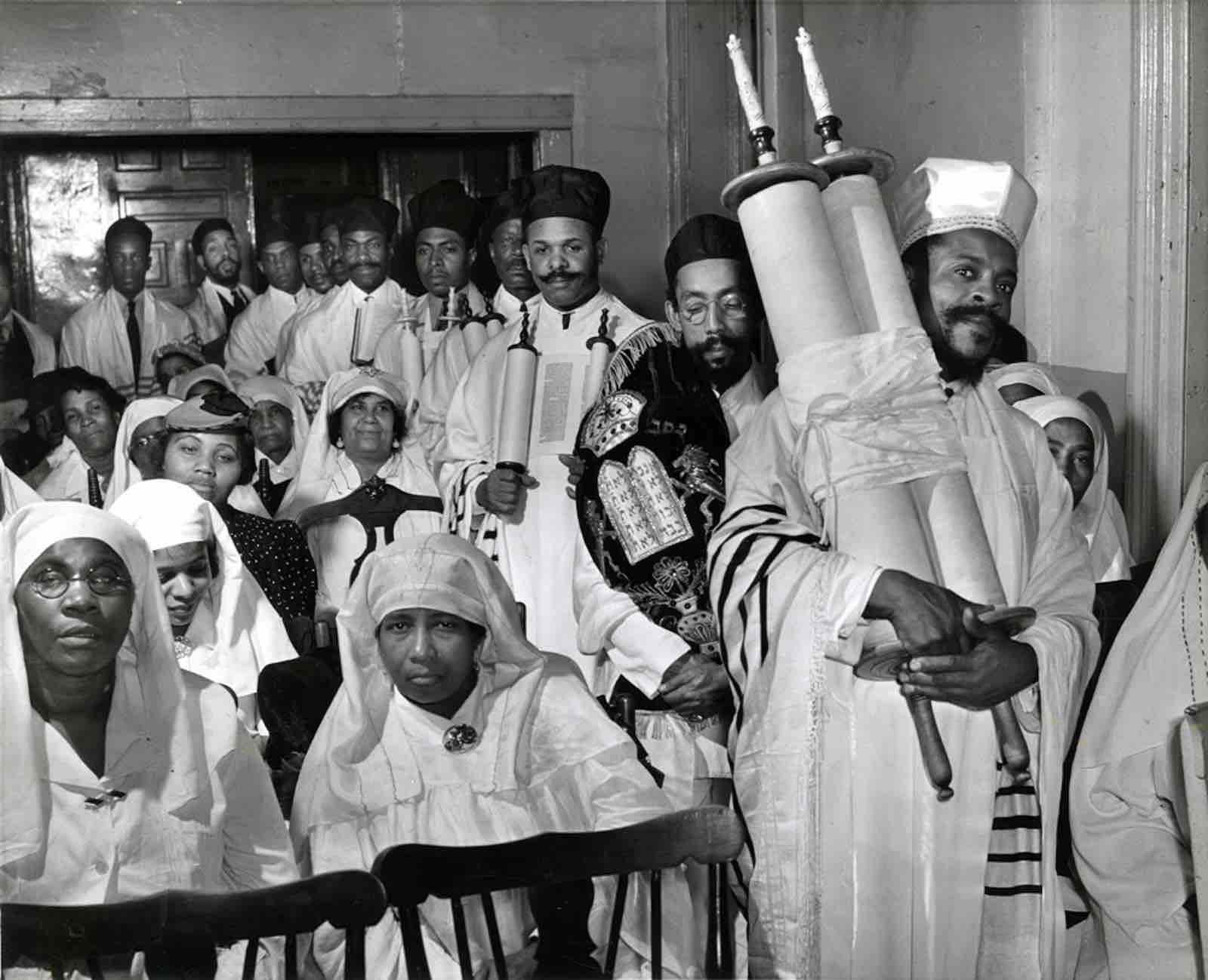 Alexander Alland (1902-1989), Rabbi Wentworth Arthur Matthew (1892-1973) holding a Torah scroll during the Simchat Torah holiday, 1940. Gelatin silver print.